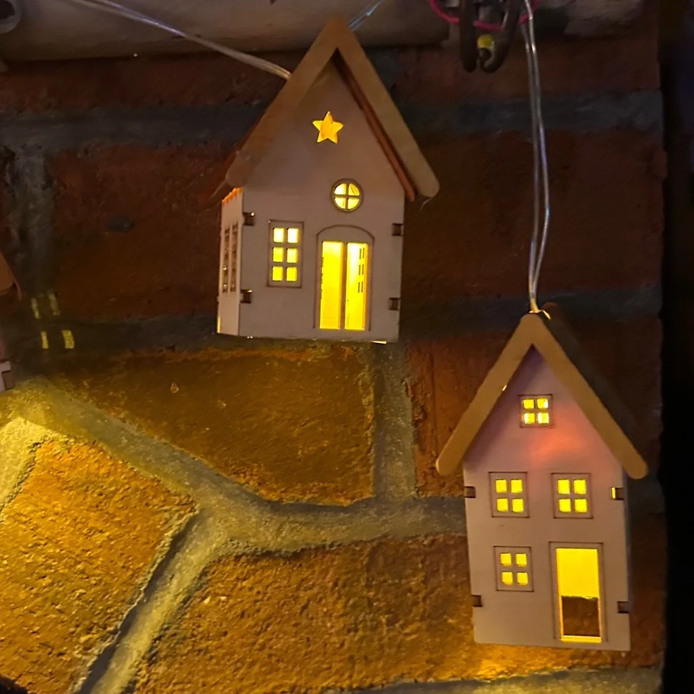 2 sets of tiny House garland with battery operated lights inside. 10 ft cord.